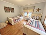 Twin bedroom has two twin beds and twin trundle
